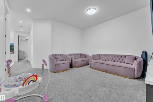 Carpeted room with white walls, recessed lighting, and a flush-mount ceiling fixture - 16816 49 Street, Edmonton, AB 