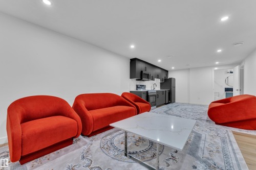 Open-concept living space featuring recessed lighting, light wood-finish flooring, and a modern kitchenette - 16816 49 Street, Edmonton, AB 