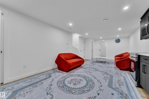 Open-concept room featuring light wood-finish flooring, white walls, and recessed lighting - 16816 49 Street, Edmonton, AB 
