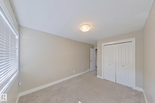 Neutral tone walls with white baseboards frame this carpeted room - 4343 Crabapple Crescent, Edmonton, AB 