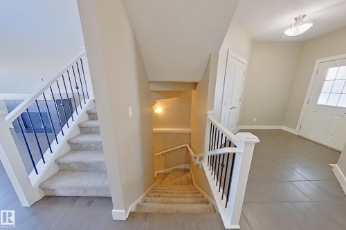 Foyer with tiled flooring, white front door with windowpanes, and flush-mount ceiling fixture - 4343 Crabapple Crescent, Edmonton, AB 