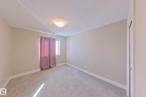 Interior room featuring light gray carpet, neutral painted walls, and white baseboards - 4343 Crabapple Crescent, Edmonton, AB 