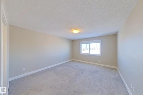Spacious room featuring neutral carpeting and light-toned walls - 4343 Crabapple Crescent, Edmonton, AB 