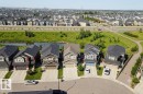Residential neighborhood featuring a curvilinear street layout and individual two-story homes with attached garages - 4343 Crabapple Crescent, Edmonton, AB 