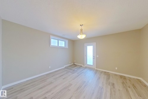 Light wood-finish flooring with neutral wall tones - 4343 Crabapple Crescent, Edmonton, AB 