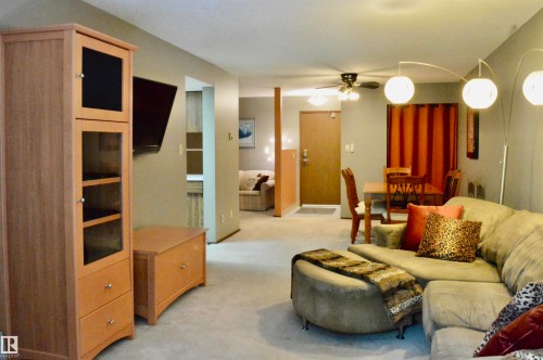 Carpeted living area with light gray walls - 302 10335 118 Street, Edmonton, AB 