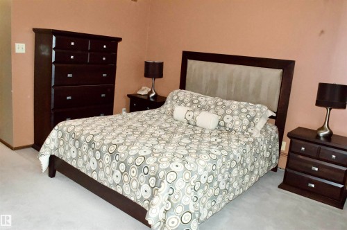 Bedroom featuring light-colored wall paint and wall-to-wall carpeting - 302 10335 118 Street, Edmonton, AB 