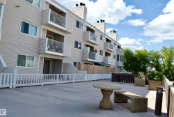 Multi-level building with individual balconies and patios, featuring horizontal siding - 