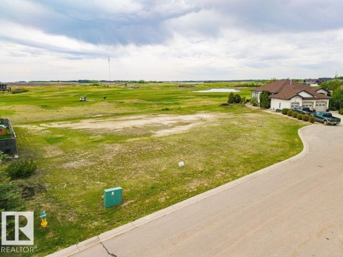 Expansive land parcel with surrounding green space, paved street frontage, and established curb appeal - 25 Whitetail Green, Mundare, AB 