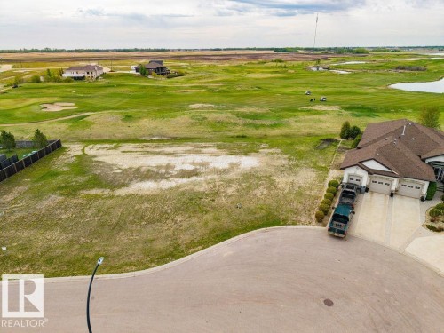 Expansive undeveloped lot with direct frontage on a manicured golf course, featuring a gently curving cul-de-sac - 25 Whitetail Green, Mundare, AB 