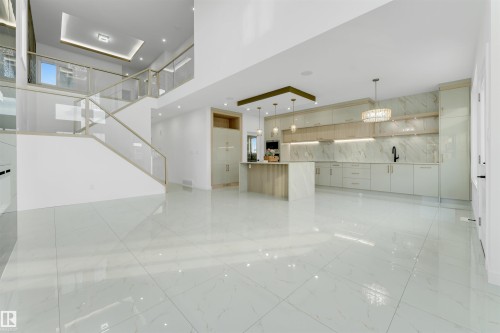 Open-concept living space with large format polished tile flooring - 1536 64 Ave, Rural Leduc County, AB 