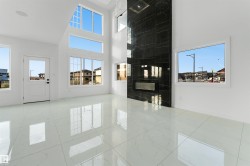 Spacious interior featuring high ceilings, white walls, and polished white tile flooring - 