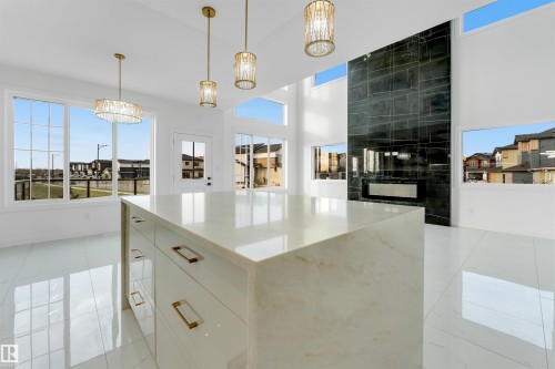 Contemporary kitchen island featuring a light-toned countertop and integrated storage - 1536 64 Ave, Rural Leduc County, AB 