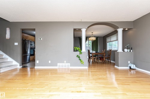 Expansive hardwood flooring throughout the main living area - 11512 24 Avenue, Edmonton, AB 