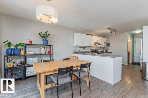 Open-concept kitchen and dining area featuring wood-finish flooring - 1816 36 Avenue, Edmonton, AB 