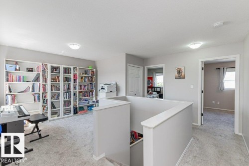 Upper-level landing featuring light gray walls and plush gray carpeting - 1816 36 Avenue, Edmonton, AB 