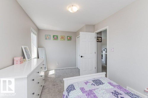 Neutral-toned room featuring a single window, overhead lighting, and grey carpet flooring - 1816 36 Avenue, Edmonton, AB 