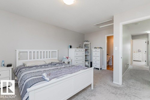 Carpeted room with light grey walls and a sloped ceiling - 1816 36 Avenue, Edmonton, AB 