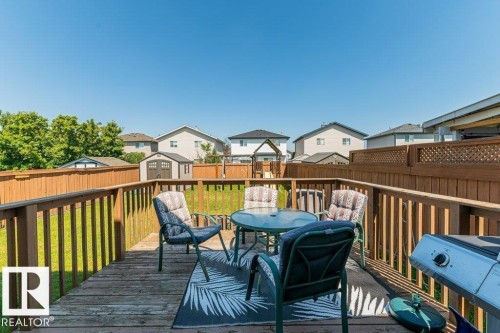 Spacious wood deck with wood railing, offering ample outdoor living space - 1816 36 Avenue, Edmonton, AB 
