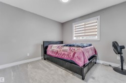 Carpeted room featuring light gray walls, white baseboards, and a window with blinds - 