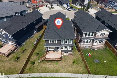 Rear exterior featuring a multi-level wood deck, a fenced yard, and a shingled roof - 715 Ebbers Place Nw, Edmonton, AB 