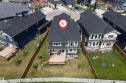 Rear exterior featuring a multi-level wood deck, a fenced yard, and a shingled roof - 