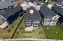 Rear exterior featuring a multi-level wood deck, a fenced yard, and a shingled roof - 715 Ebbers Place Nw, Edmonton, AB 