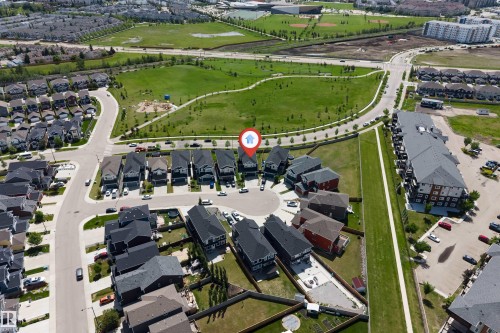 Aerial perspective showcasing a residential development with a large green space - 715 Ebbers Place Nw, Edmonton, AB 