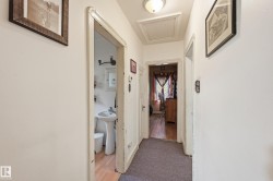 Hallway featuring white painted walls and a flush-mount ceiling light - 