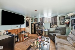 Recreation room with light blue walls and wood-finish wainscoting - 