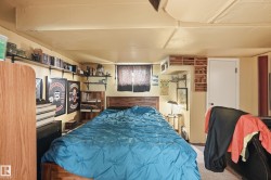 Interior space featuring a window with dark coverings, wood-finish flooring, and a white interior door - 