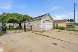 Detached garage structure with a pitched roof and a white overhead door - 