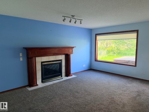 727 Balfour Close Nw, Edmonton, AB - Indoor Photo Showing Living Room With Fireplace