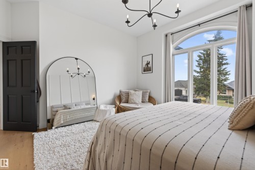 Arch-top window with multi-pane design - 711 Beach Avenue, Cold Lake, AB - Indoor Photo Showing Bedroom