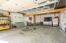 Spacious garage featuring concrete flooring and a paneled ceiling - 711 Beach Avenue, Cold Lake, AB  - Indoor Photo Showing Garage 