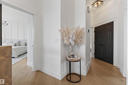 Light wood-finish flooring extends through this interior hallway - 711 Beach Avenue, Cold Lake, AB - Indoor