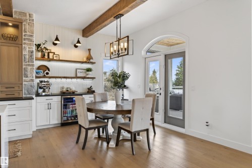 Open concept dining area featuring wood-finish flooring and an exposed wood beam - 711 Beach Avenue, Cold Lake, AB - Indoor Photo Showing Dining Room