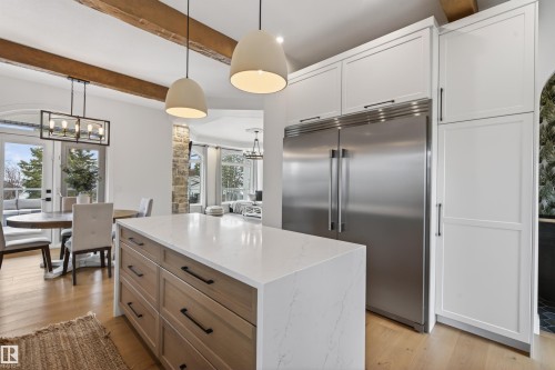 Kitchen island with a light-toned countertop, wood-finish drawers, and matte black hardware - 711 Beach Avenue, Cold Lake, AB - Indoor