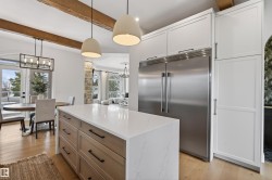 Kitchen island with a light-toned countertop, wood-finish drawers, and matte black hardware - 
