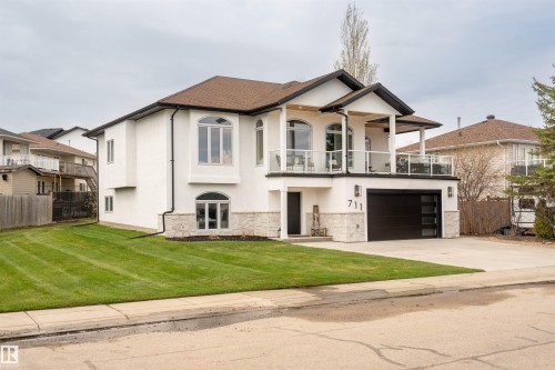 Contemporary two-story residence with white stucco exterior and stone veneer accents - 711 Beach Avenue, Cold Lake, AB - Outdoor