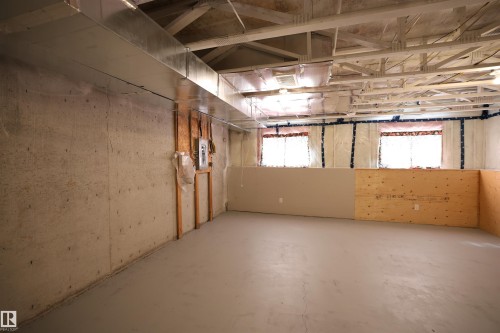 Unfinished basement featuring exposed concrete walls and ceiling joists - 11120 132 Street, Edmonton, AB 