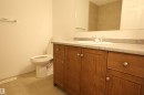 Bathroom vanity with a light-colored countertop and integrated sink - 11120 132 Street, Edmonton, AB 