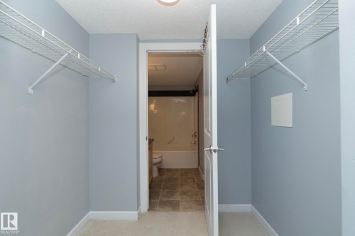 Interior closet space featuring light gray walls and wire shelving - 208 3719 Whitelaw Lane, Edmonton, AB 
