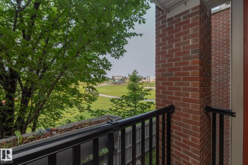 Balcony overlooking open green space and mature trees - 208 3719 Whitelaw Lane, Edmonton, AB 