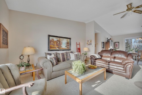Carpeted living area with a ceiling fan and lofted ceiling - A49375 Rr 243, Rural Leduc County, AB 