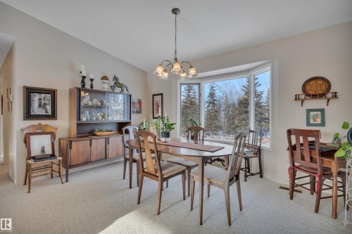 Dining area with light carpet, vaulted ceiling, and a chandelier - A49375 Rr 243, Rural Leduc County, AB 