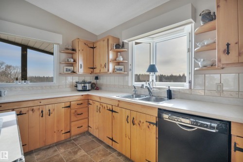 Kitchen with open shelves, black dishwasher, light countertops, backsplash, and vaulted ceiling - A49375 Rr 243, Rural Leduc County, AB 