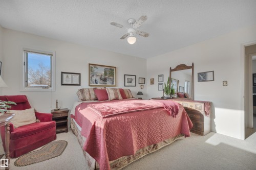 Carpeted bedroom with ceiling fan and a textured ceiling - A49375 Rr 243, Rural Leduc County, AB 