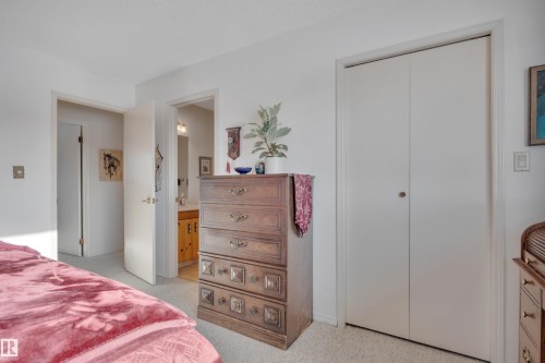 Bedroom featuring light colored carpet, a closet, and ensuite bath - A49375 Rr 243, Rural Leduc County, AB 