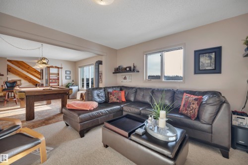 Living room featuring a textured ceiling - A49375 Rr 243, Rural Leduc County, AB 